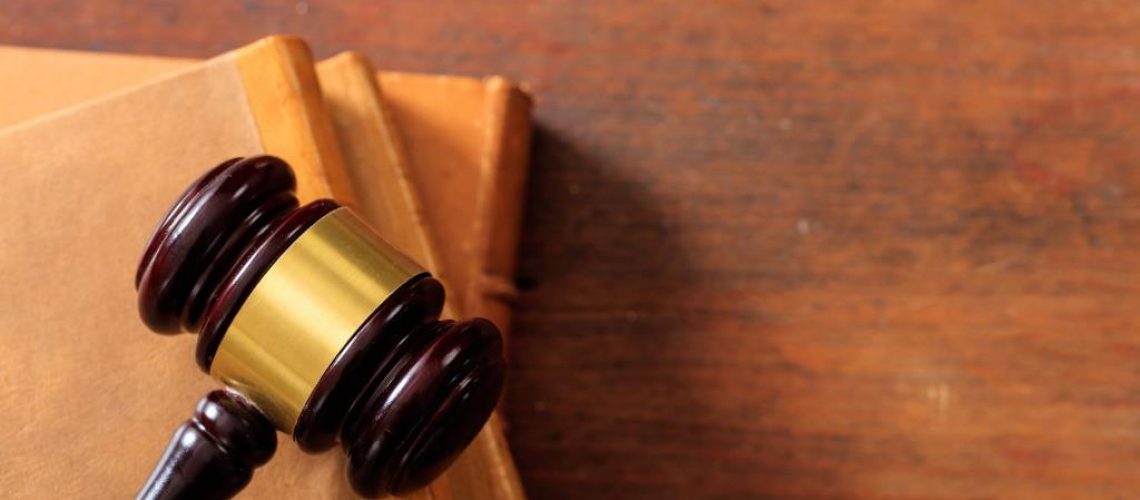 Law gavel on law books, wooden desk, copy space